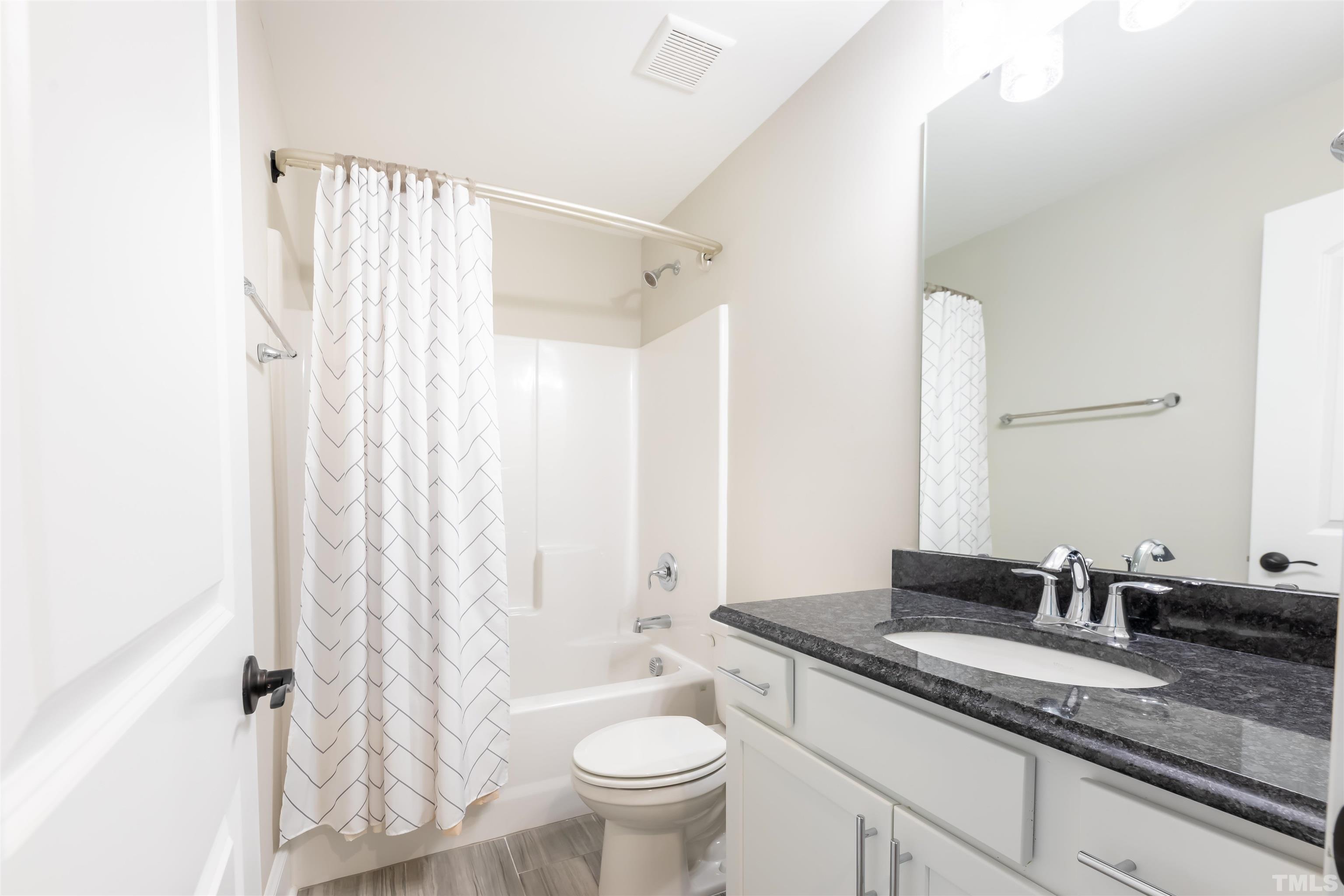 456 Adkins Ridge Road Rolesville, NC 27571 - Photo 26 of 38 a bathroom with a granite countertop sink toilet and shower