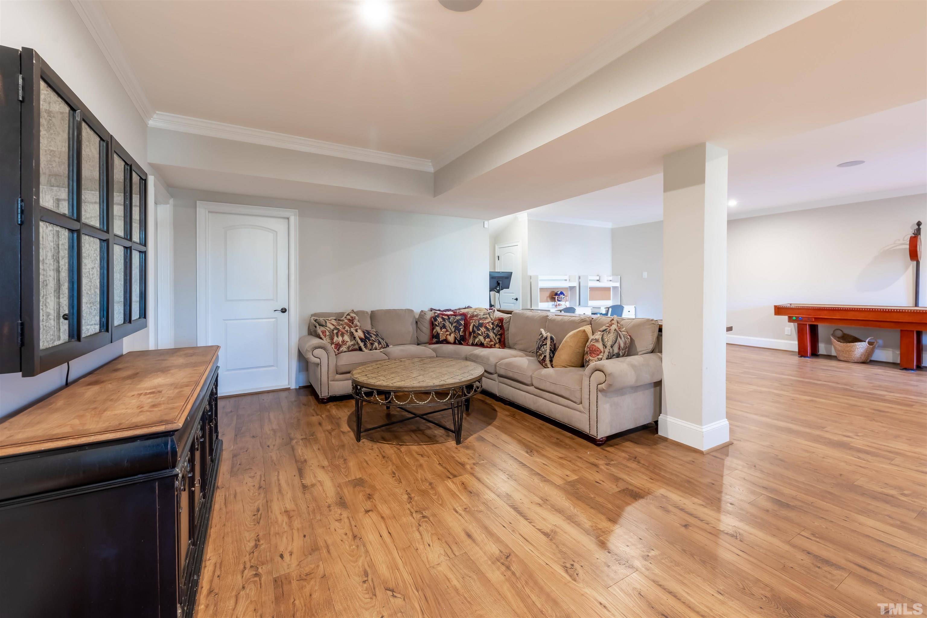 456 Adkins Ridge Road Rolesville, NC 27571 - Photo 29 of 38 a living room with furniture and a wooden floor