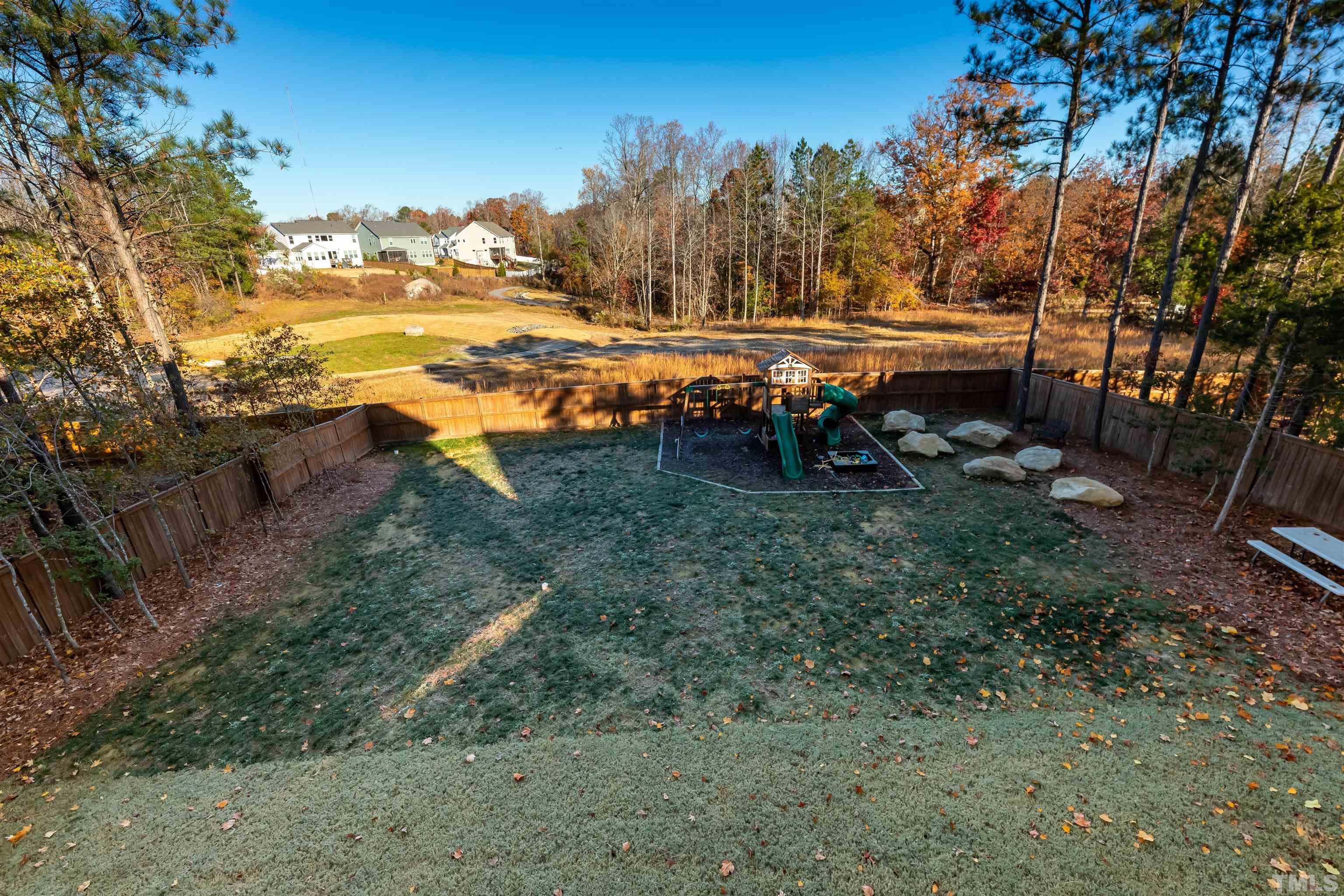 456 Adkins Ridge Road Rolesville, NC 27571 - Photo 33 of 38 a view of a yard with wooden fence