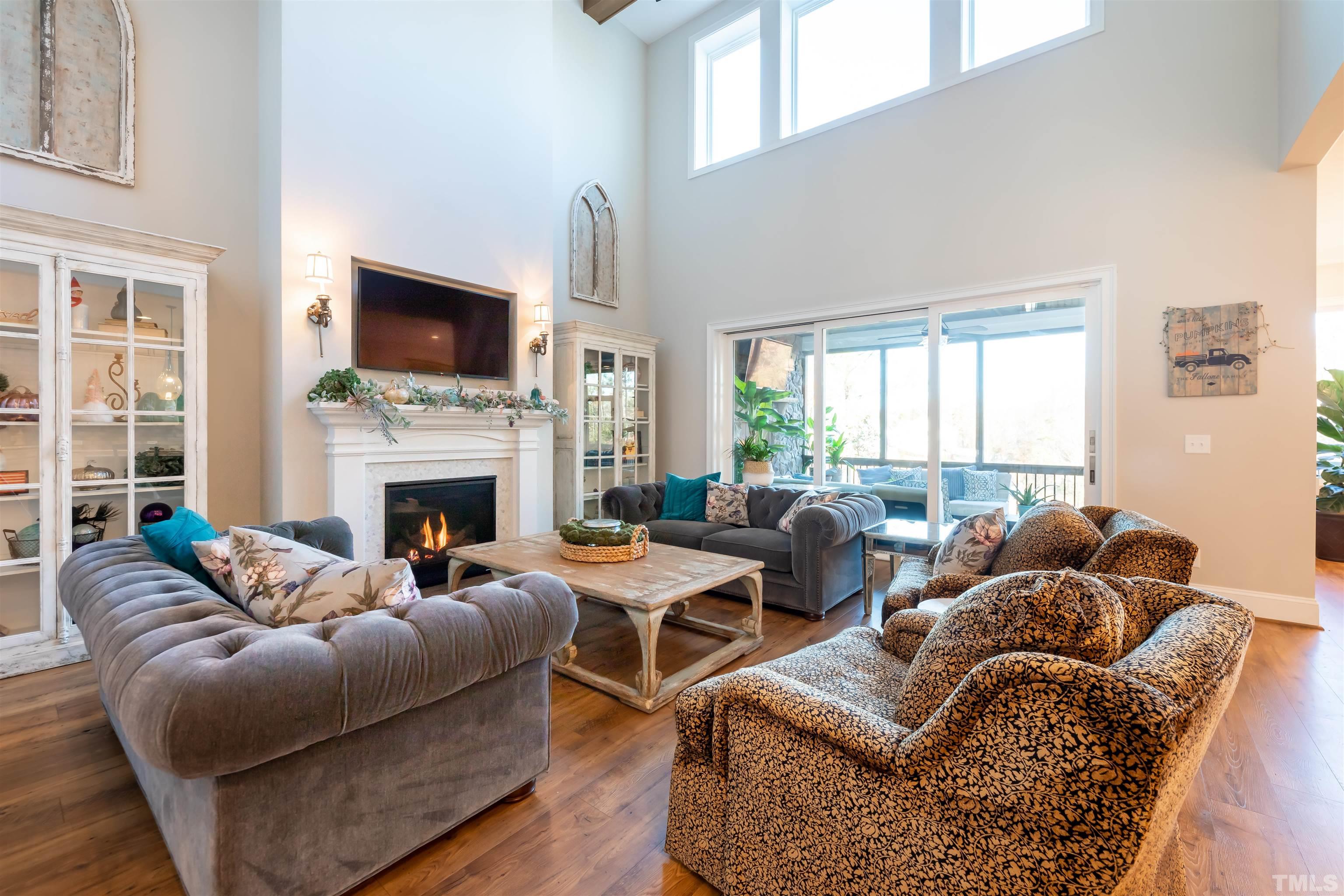 456 Adkins Ridge Road Rolesville, NC 27571 - Photo 5 of 38 a living room with furniture a flat screen tv and a fireplace