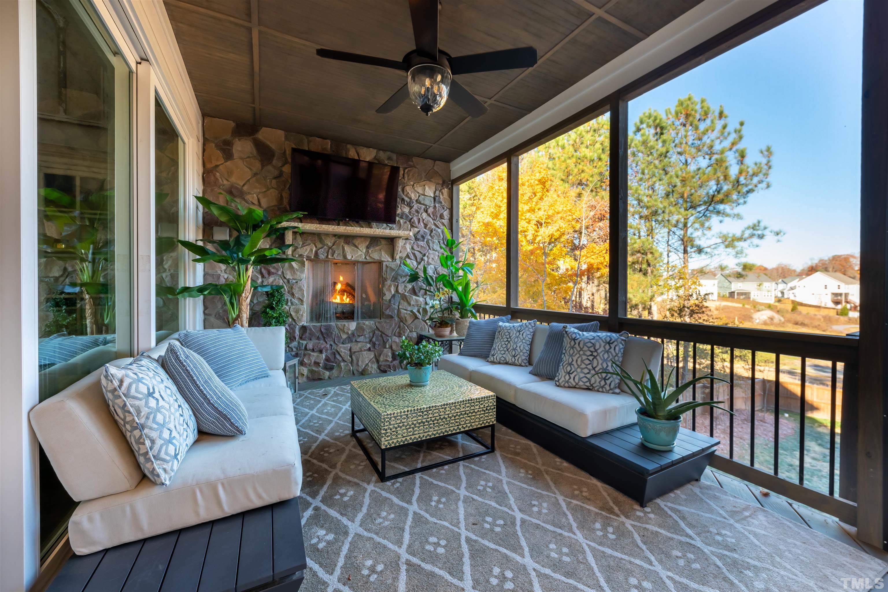 456 Adkins Ridge Road Rolesville, NC 27571 - Photo 9 of 38 a living room with patio furniture and a floor to ceiling window