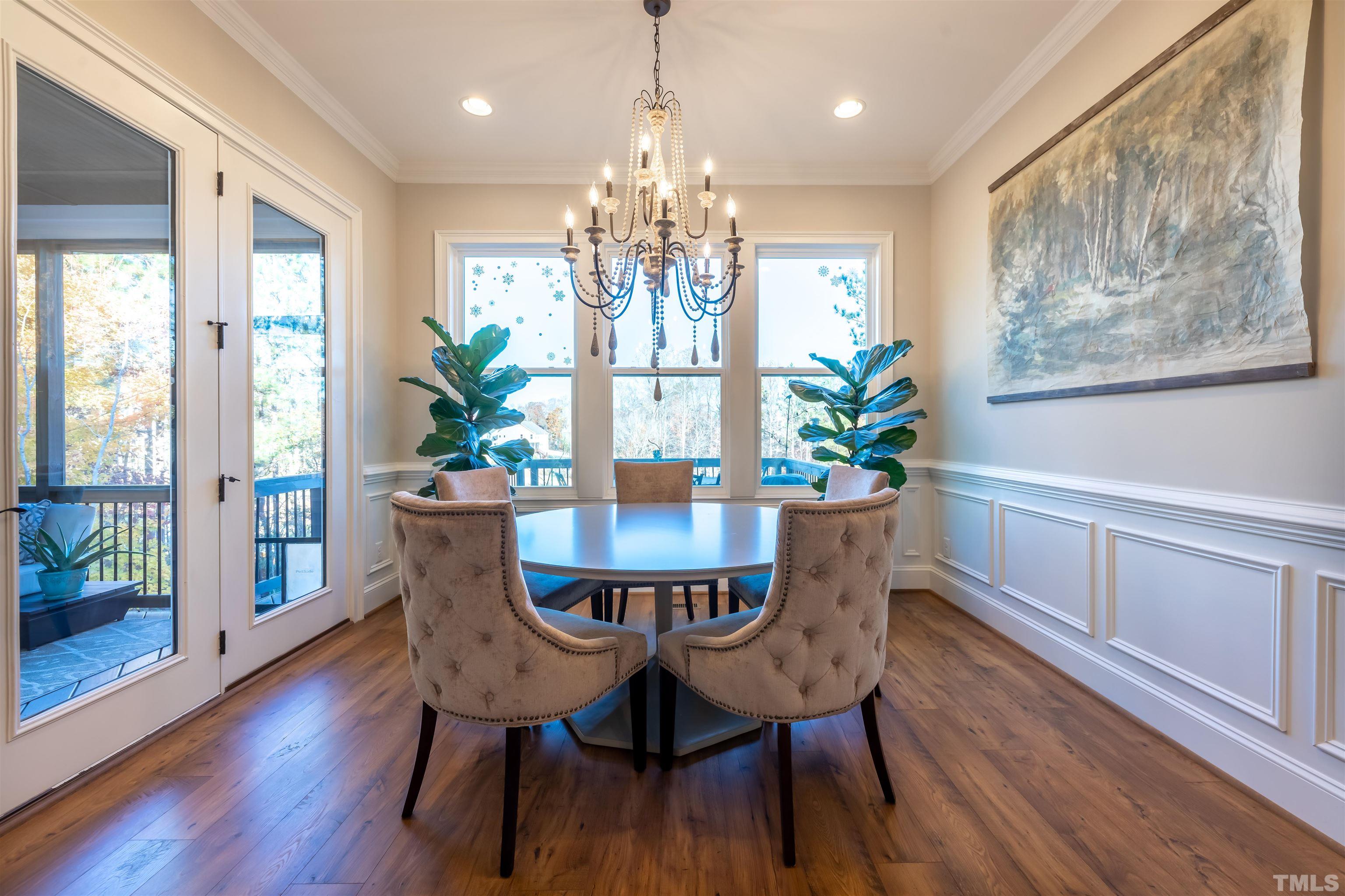 456 Adkins Ridge Road Rolesville, NC 27571 - Photo 10 of 38 a view of a dining room with furniture wooden floor and chandelier