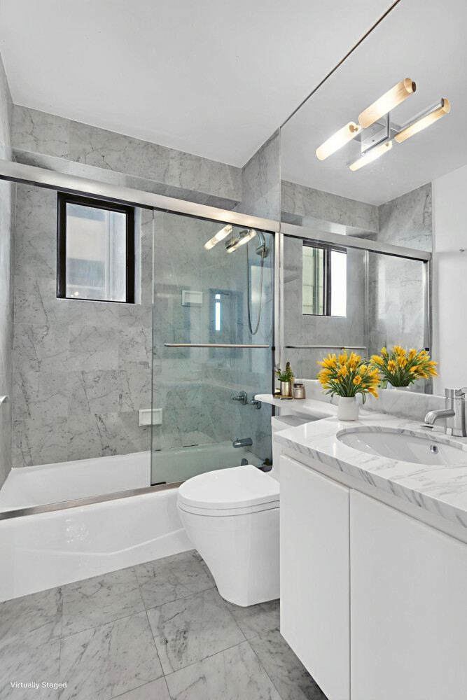 45 East 25th Street, Unit 37A Manhattan, NY 10010 - Photo 2 of 13 a bathroom with a sink a toilet and shower