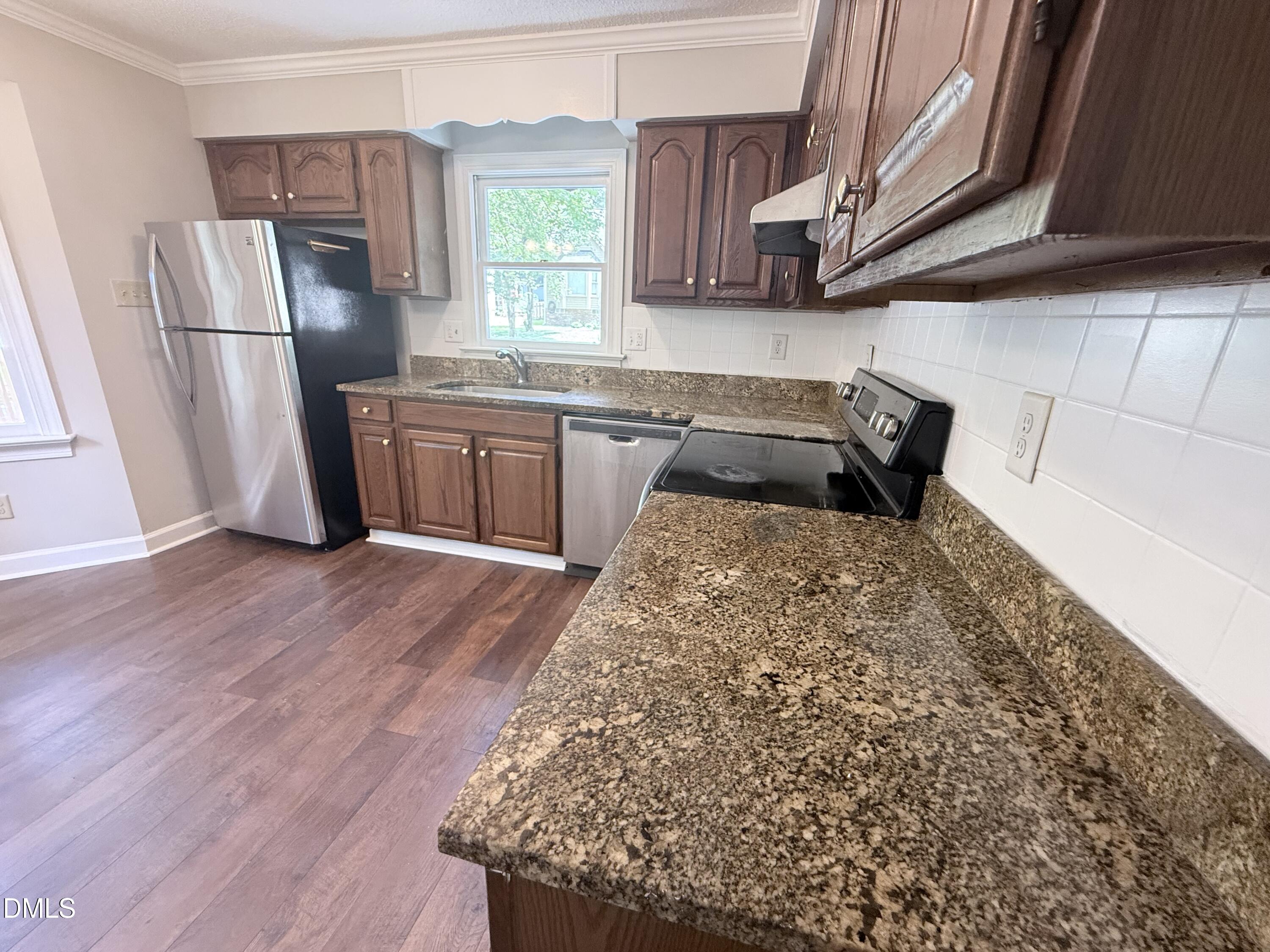 2900 Broadlands Drive Raleigh, NC 27604 - Photo 40 of 60 a kitchen with stainless steel appliances granite countertop a refrigerator a stove a sink and a microwave
