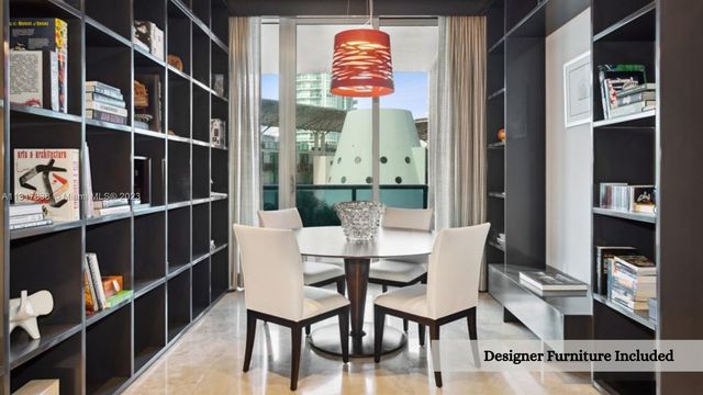 a dining room with furniture and a window