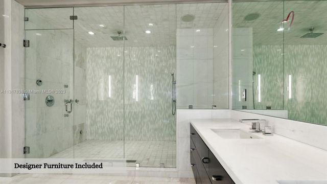 a bathroom with a shower sink and mirror