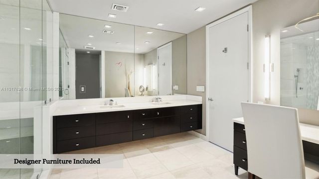 a spacious bathroom with a double vanity sink and mirror