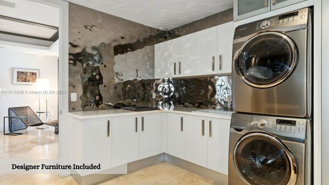a view of a kitchen with sink washer and dryer