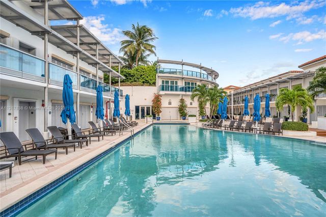 a view of a swimming pool with outdoor seating