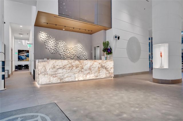 a view of a livingroom with wooden floor and a large window