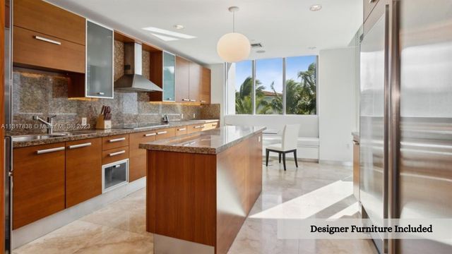 a kitchen with stainless steel appliances granite countertop a sink a stove and a refrigerator
