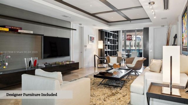 a living room with furniture a rug and a flat screen tv
