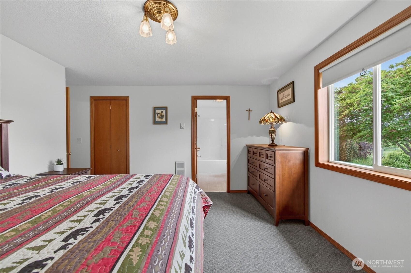 218 West Sunny Sands Road Cathlamet, WA 98612 - Photo 18 of 40 a bedroom with a bed and a chandelier