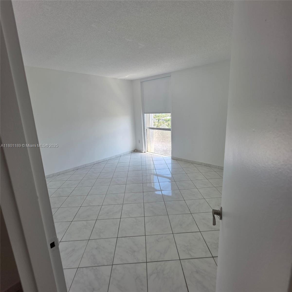 2350 Northeast 135th Street, Unit 1010 North Miami, FL 33181 - Photo 11 of 23 a view of an empty room and window