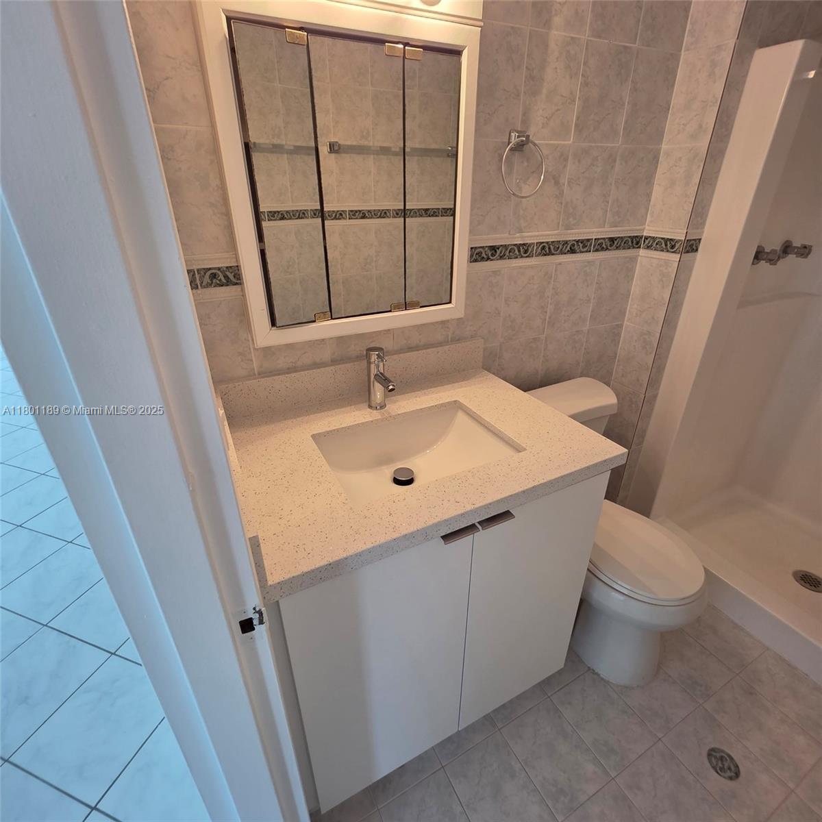 2350 Northeast 135th Street, Unit 1010 North Miami, FL 33181 - Photo 13 of 23 a bathroom with a sink and a vanity