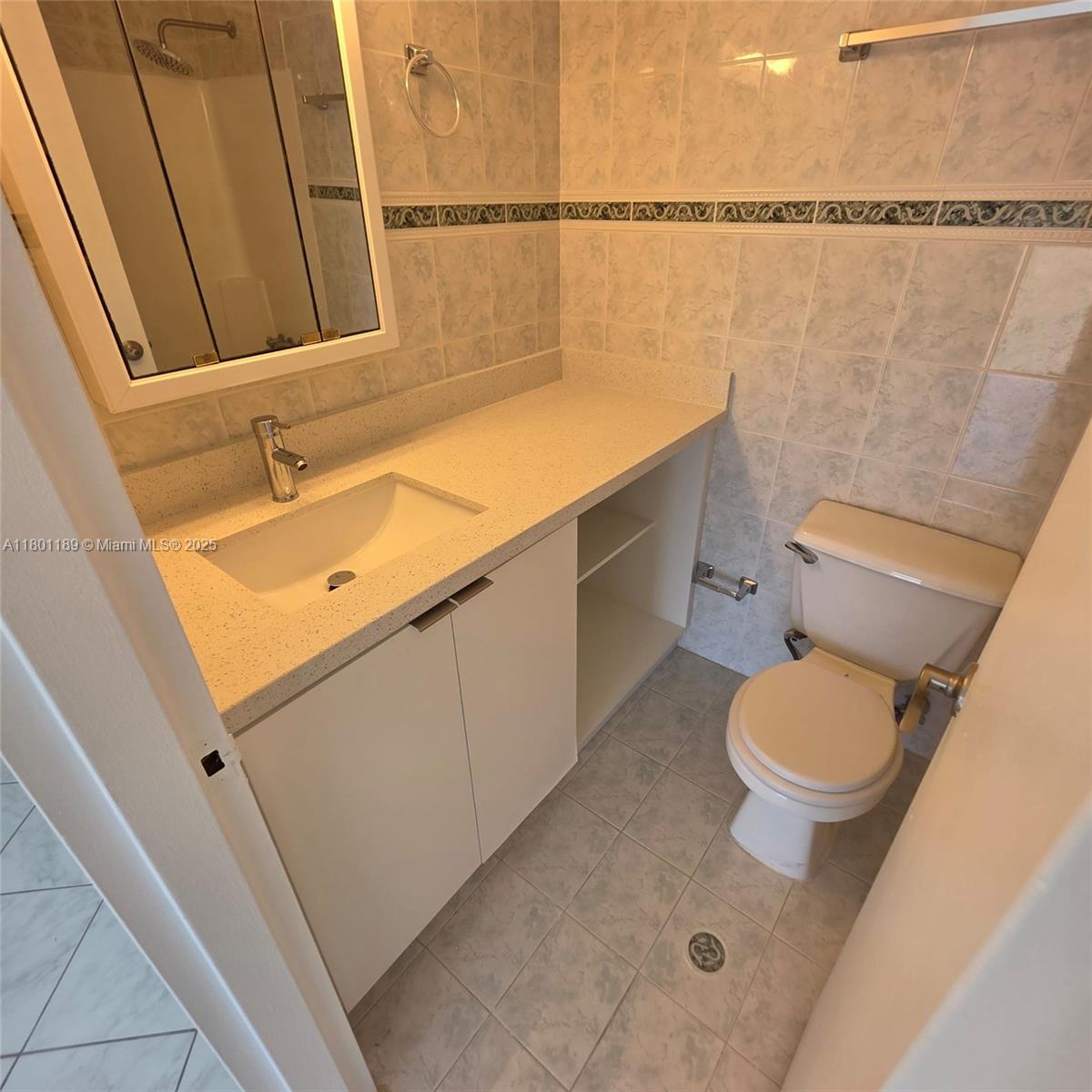 2350 Northeast 135th Street, Unit 1010 North Miami, FL 33181 - Photo 14 of 23 a bathroom with a sink a toilet and shower