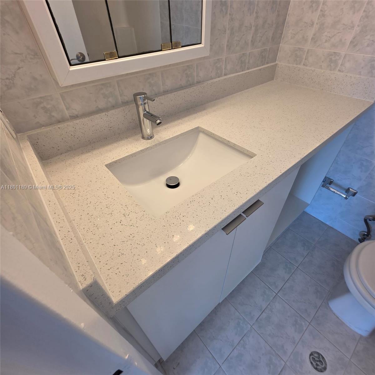 2350 Northeast 135th Street, Unit 1010 North Miami, FL 33181 - Photo 18 of 23 a bathroom with a sink and a toilet