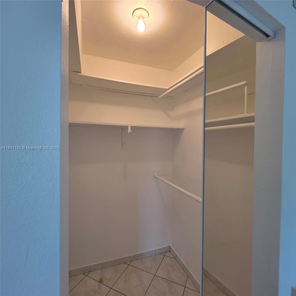 2350 Northeast 135th Street, Unit 1010 North Miami, FL 33181 - Photo 21 of 23 a view of an empty walk in closet