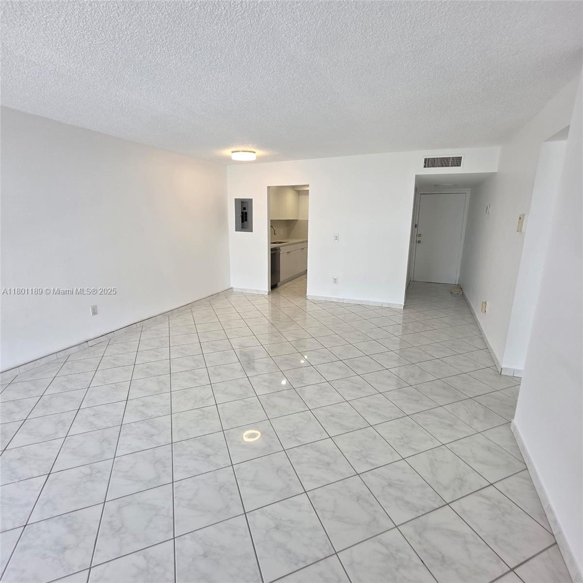 2350 Northeast 135th Street, Unit 1010 North Miami, FL 33181 - Photo 22 of 23 an empty room with white walls and tiles
