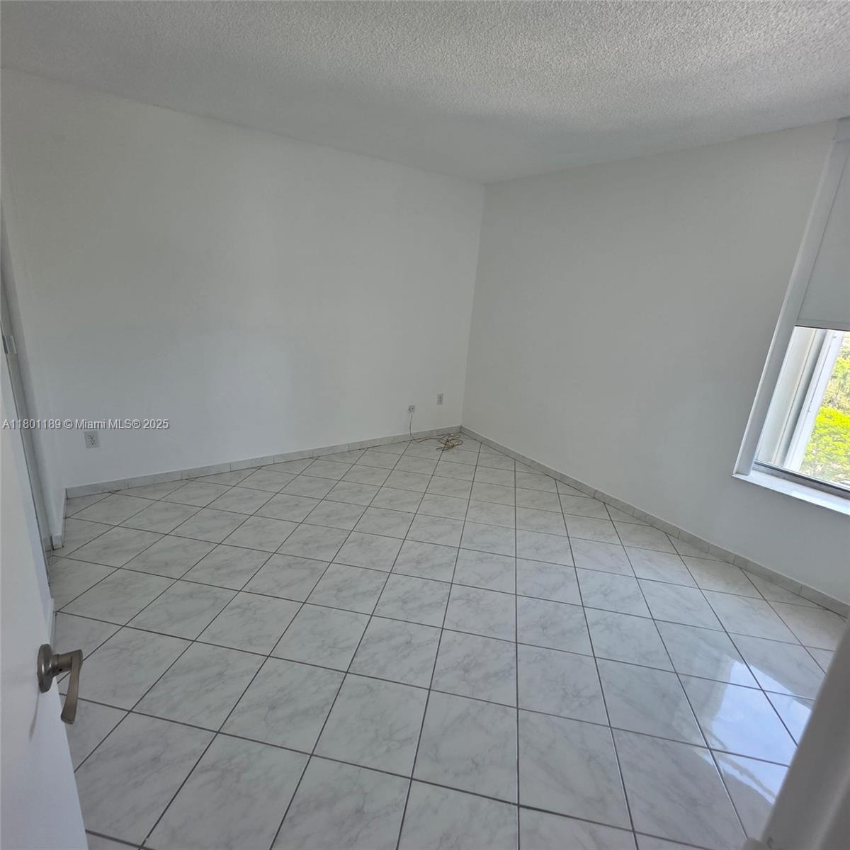 2350 Northeast 135th Street, Unit 1010 North Miami, FL 33181 - Photo 23 of 23 an empty room with windows