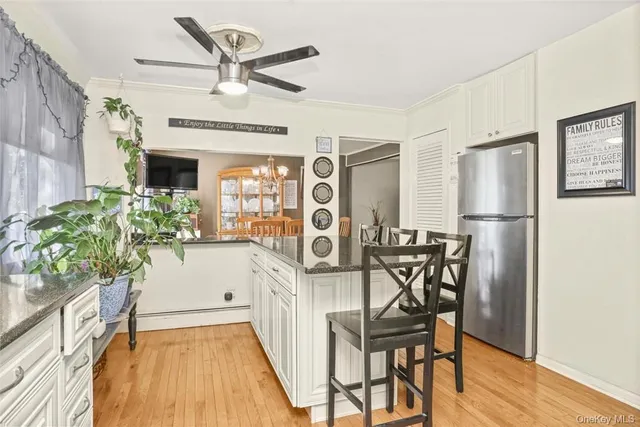 a view of a dinning room with furniture window and wooden floor