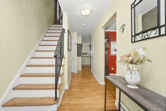 a view of a hallway with wooden floor and entryway