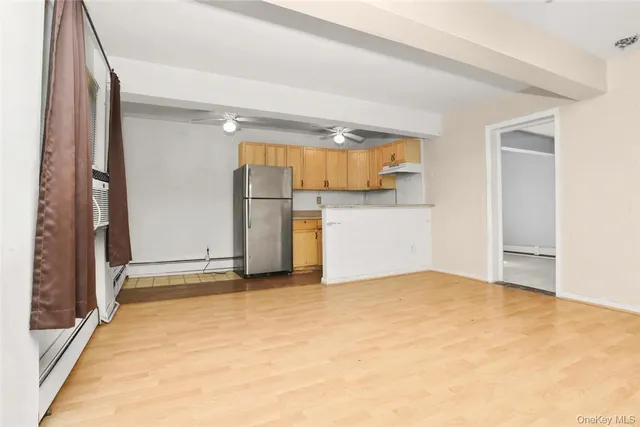 a view of a room with a refrigerator and a window