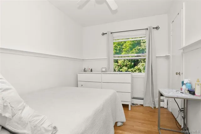 a bedroom with a bed a table and a window