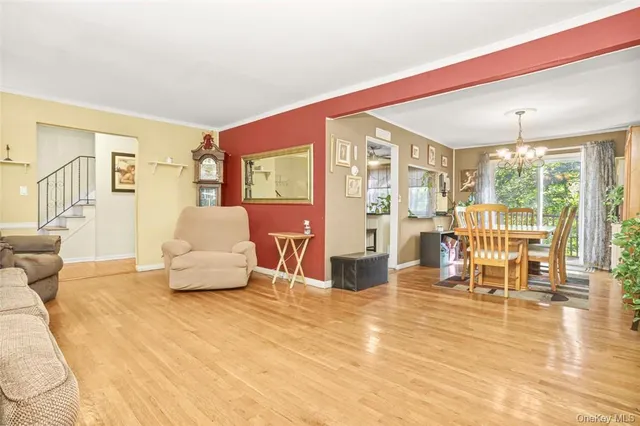 a living room with furniture and a table with kitchen view