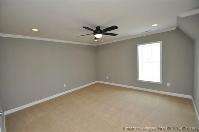 an empty room with ceiling fan and window