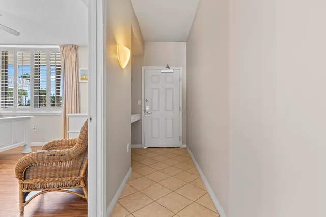 a spacious bedroom with a bed and a view of kitchen