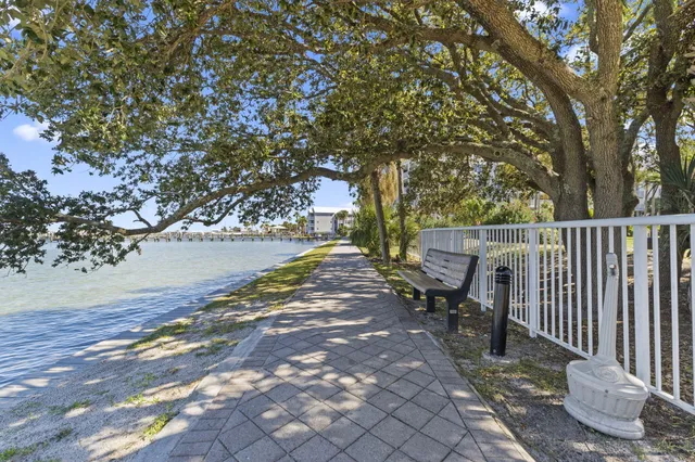 a view of a patio with a table and chairs and potted plants