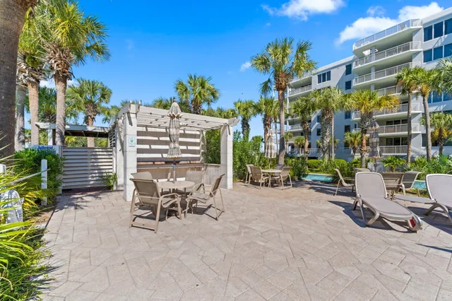 a swimming pool with outdoor seating and yard