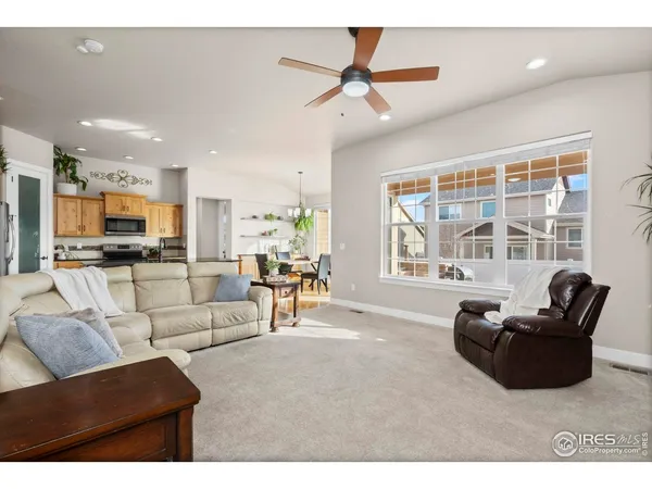 a living room with furniture a fireplace and a large window