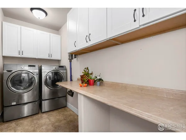 a kitchen with stainless steel appliances kitchen island granite countertop a refrigerator and a sink