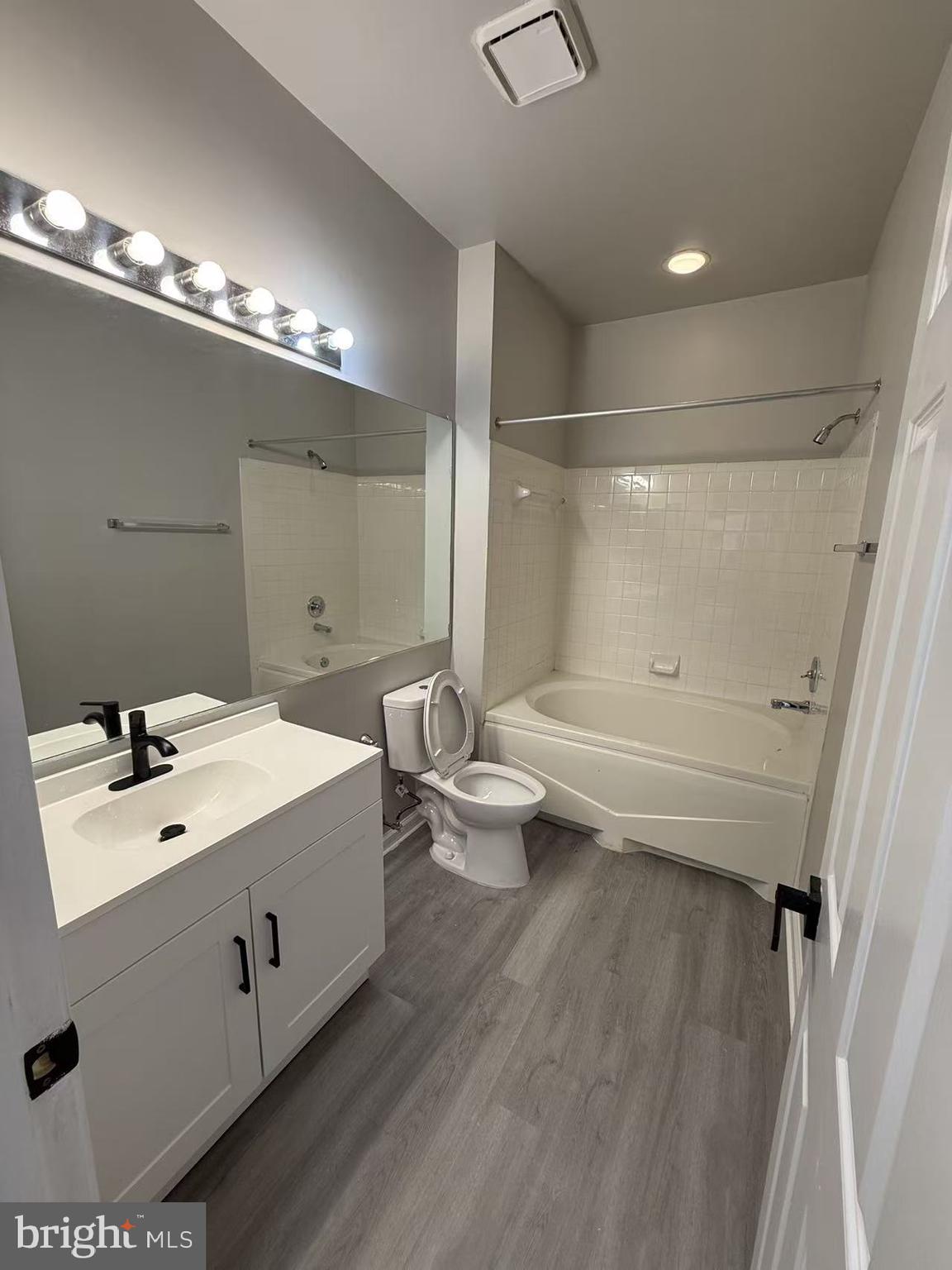 4400 Silverbrook Lane, Unit F003 Owings Mills, MD 21117 - Photo 12 of 17 a bathroom with a double vanity sink toilet and shower