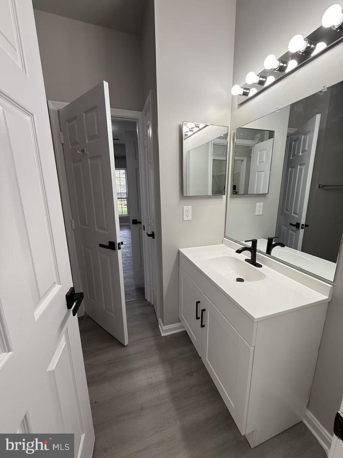 4400 Silverbrook Lane, Unit F003 Owings Mills, MD 21117 - Photo 5 of 17 a bathroom with a sink a toilet a mirror and vanity
