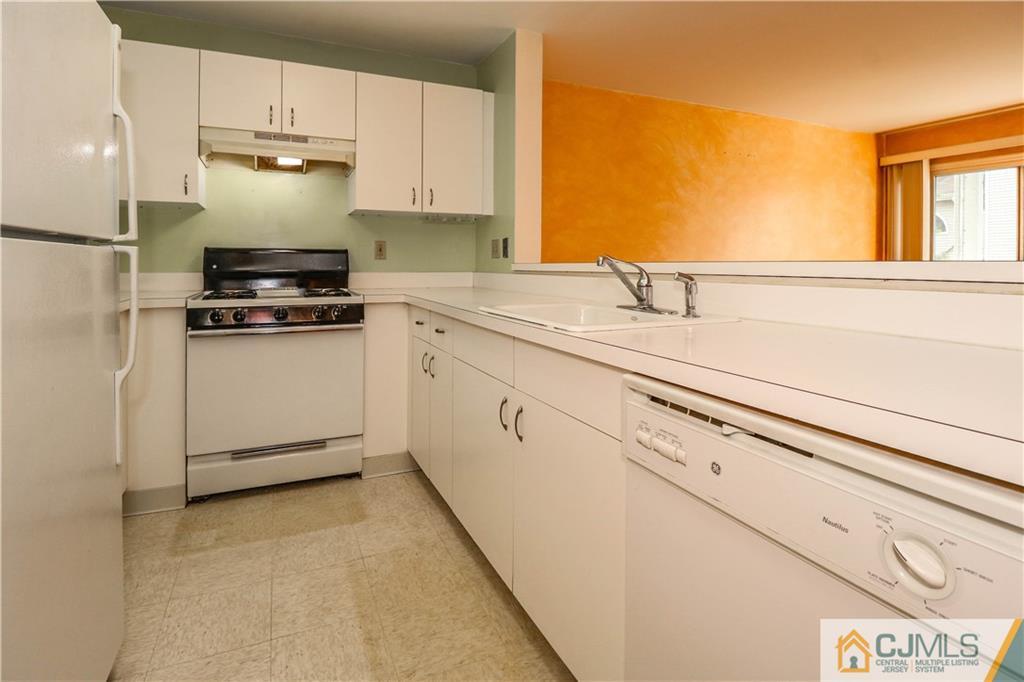 825 Edpas Road, Unit 825 New Brunswick, NJ 08901 - Photo 3 of 25 a kitchen with granite countertop white cabinets and white appliances