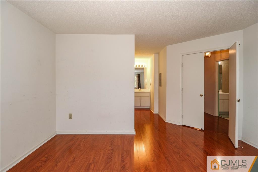 825 Edpas Road, Unit 825 New Brunswick, NJ 08901 - Photo 22 of 25 a view of a hallway with wooden floor