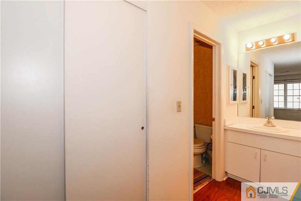 825 Edpas Road, Unit 825 New Brunswick, NJ 08901 - Photo 23 of 25 a bathroom with a sink and a mirror