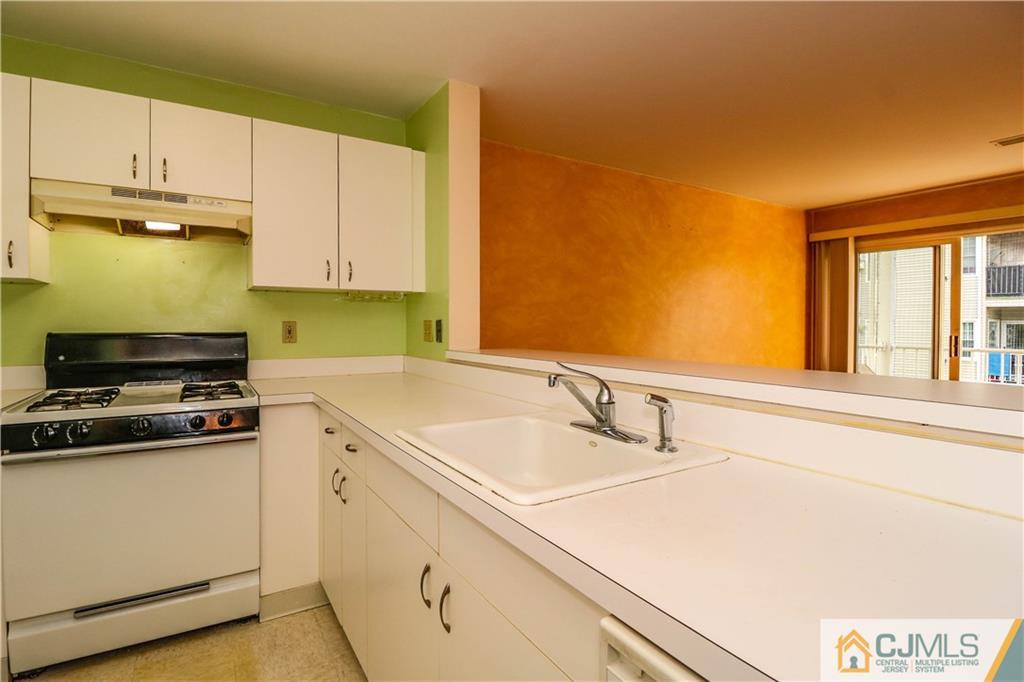 825 Edpas Road, Unit 825 New Brunswick, NJ 08901 - Photo 4 of 25 a kitchen with stainless steel appliances a sink stove and cabinets