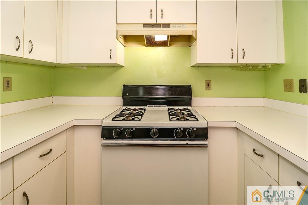 825 Edpas Road, Unit 825 New Brunswick, NJ 08901 - Photo 5 of 25 a kitchen with a stove and a white cabinets