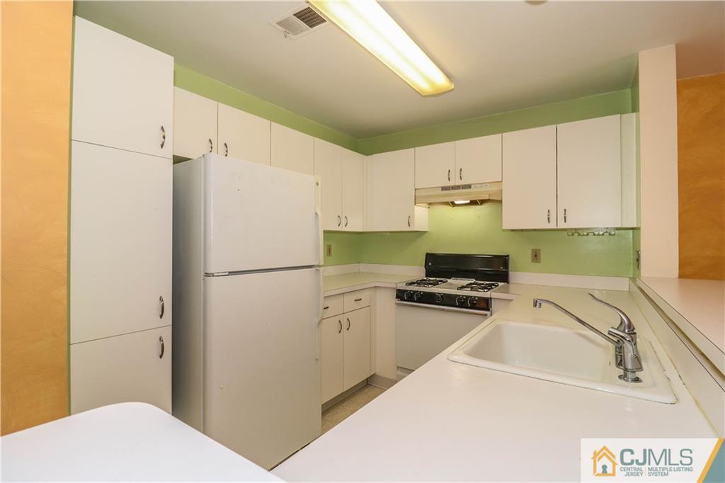 825 Edpas Road, Unit 825 New Brunswick, NJ 08901 - Photo 9 of 25 a kitchen with a refrigerator sink and stove