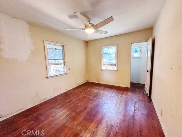 9700 Mayne Street Bellflower, CA 90706 - Photo 6 of 8 a view of an empty room with wooden floor and a window