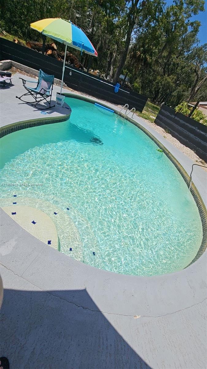 18227 Branch Road Hudson, FL 34667 - Photo 16 of 17 a view of a swimming pool and lounge chair