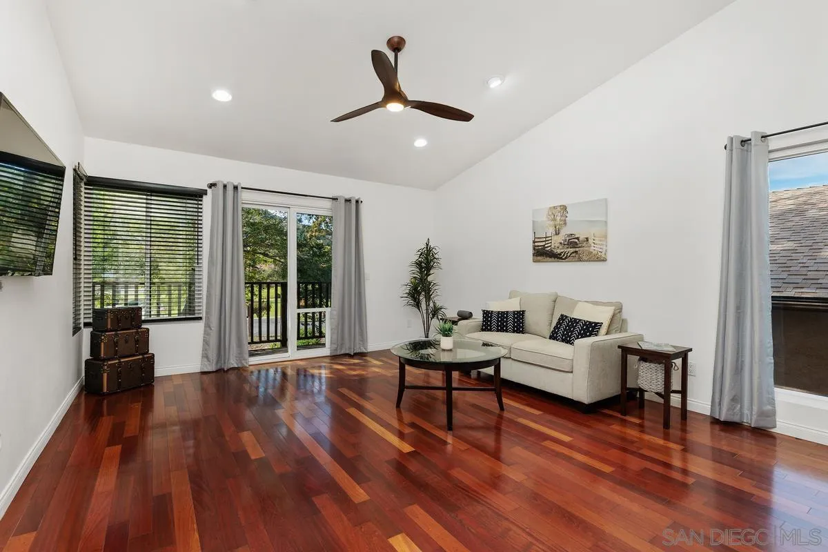 1784 Pala Lake Drive Fallbrook, CA 92028 - Photo 2 of 31 a living room with furniture floor to ceiling window and wooden floor