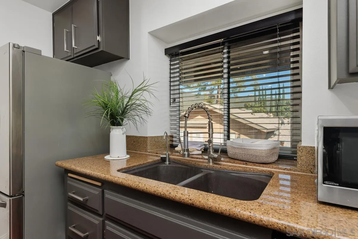 1784 Pala Lake Drive Fallbrook, CA 92028 - Photo 6 of 31 a kitchen with a sink and a potted plant