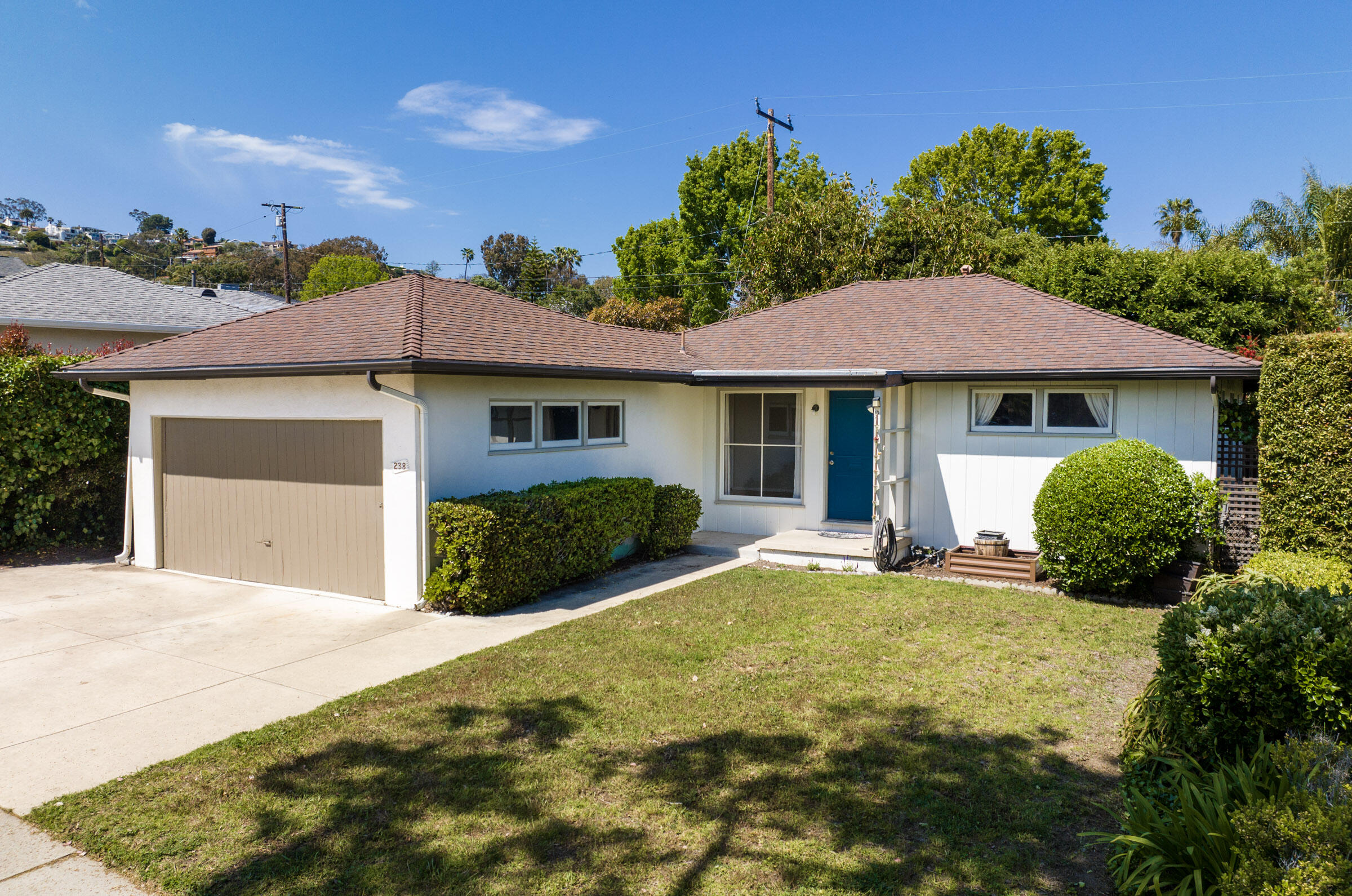 238 San Rafael Avenue Santa Barbara, CA 93109 - Photo 2 of 13 a front view of a house with a yard and garage