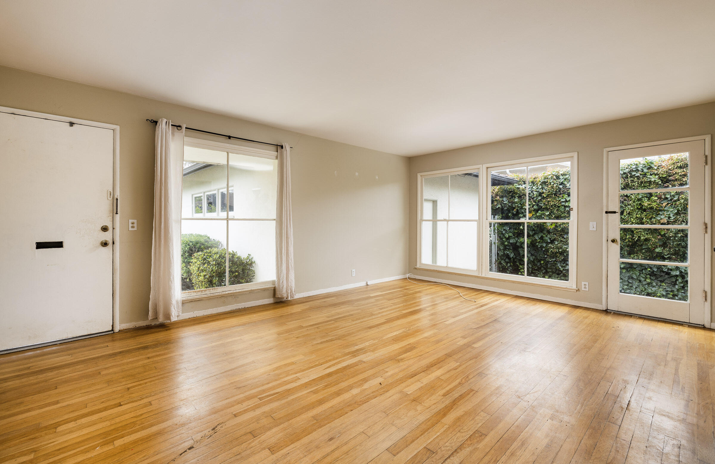 238 San Rafael Avenue Santa Barbara, CA 93109 - Photo 5 of 13 a view of an empty room with wooden floor and a window