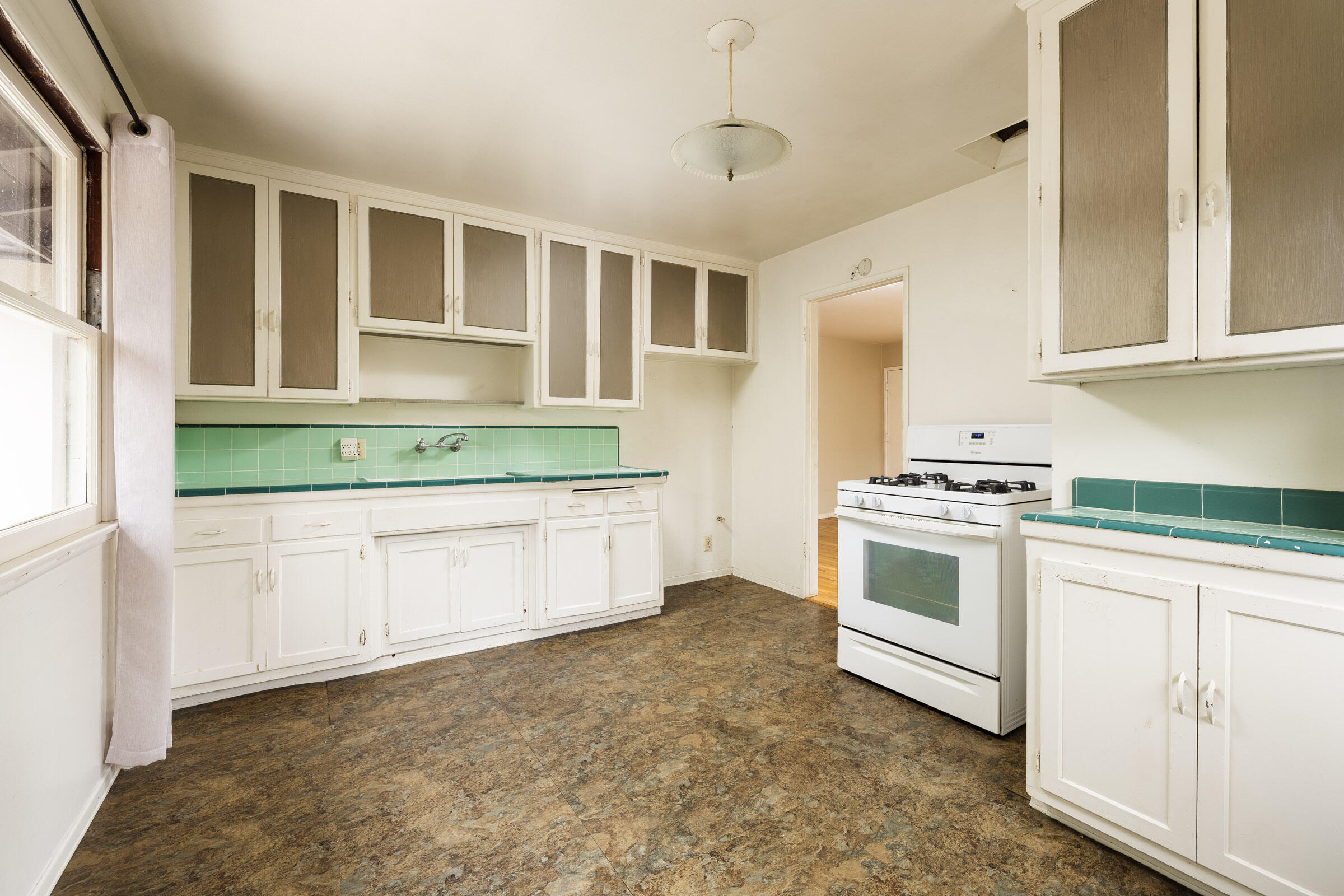 238 San Rafael Avenue Santa Barbara, CA 93109 - Photo 6 of 13 a kitchen with granite countertop white cabinets and white appliances